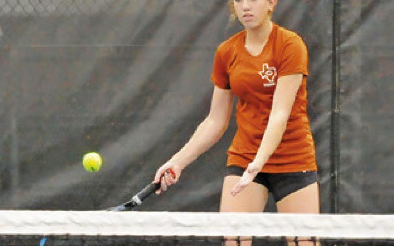 KYLIE VOGLER prepares to return the ball during a girls doubles match Friday at the Caldwell Invitational Varsity Tournament.