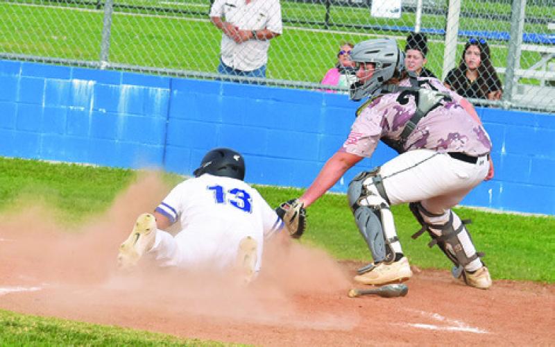 JACOB CASTANEDA slides into home for a score for Snook in an 11-1 win over Mumford. -- Tribune photo by Roy Sanders
