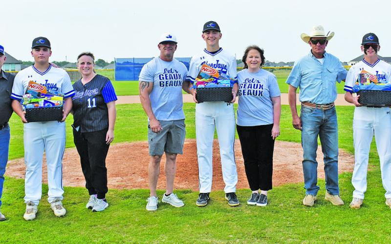 THREE SNOOK SENIORS were recognized at Senior Night. From left, Brandon Baker is joined by his parents Paul and Holly Baker. J. Beaux Hruska is joined by parents Justin Hruska and Rebecca Hruska, and Kade Junek is joined by parents Kevin Junek and Erica Junek.
