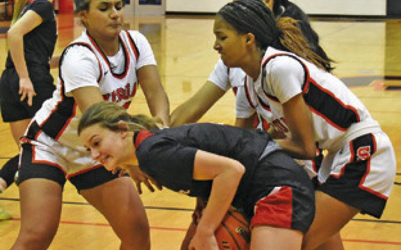 SOMERVILLE PLAYERS fight with a Burton player for possession of the ball during the Somerville-Burton game last Friday night. Tribune photo by Roy Sanders