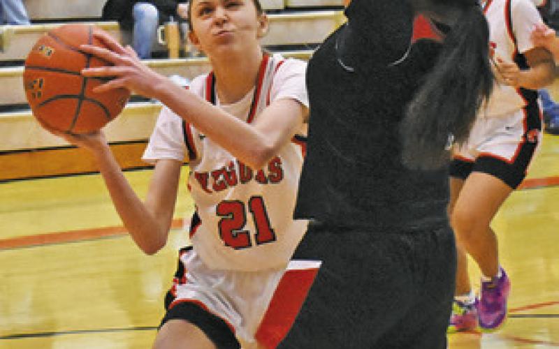 BRIDGET KALDIS eyes the basket during the Somerville-Burton game last Friday night. Tribune photo by Roy Sanders