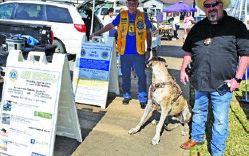 DICK WEATHERLY AND Jason Rhodes man this booth for the Lake Somerville Lions Club on Saturday at the Farmers Market in Caldwell.