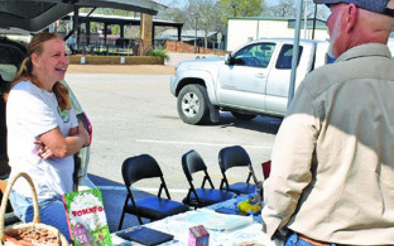 AUDREY GUTKE OF Hope Springs Farm greets a visitor on Saturday morning, Feb. 28, at the Farmers Market in downtown Caldwell.