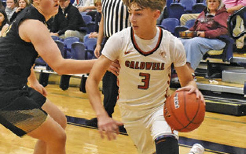 DYLAN CHAPMAN of Caldwell dribbles the ball past this Giddings defender. Tribune photo by Roy Sanders