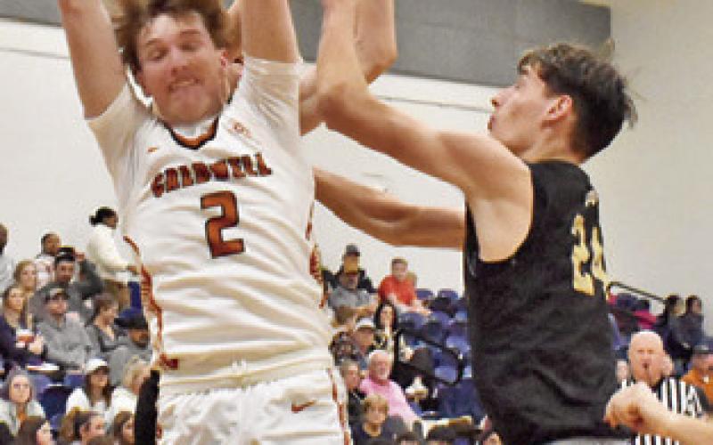 RYAN SEE OF Caldwell fights for this rebound against Giddings last Friday. Tribune photo by Roy Sanders