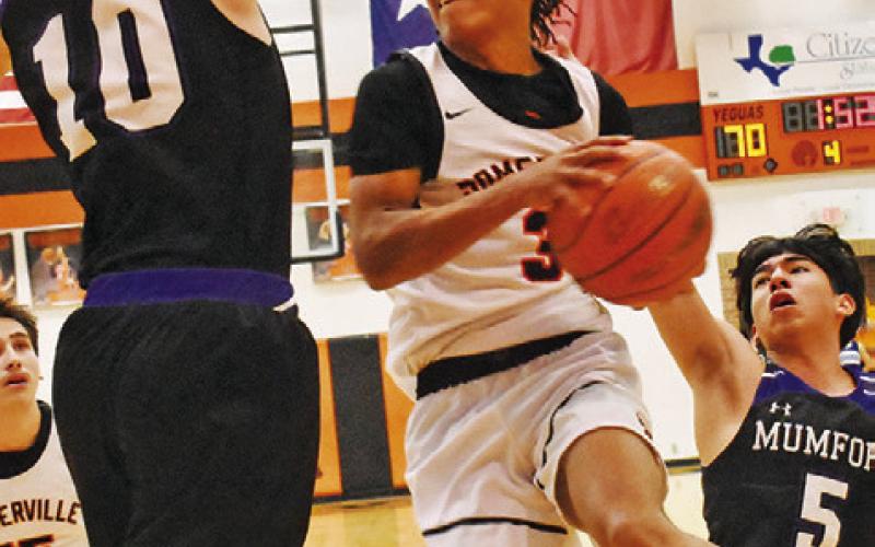 DAWUD MAJIED OF Somerville leaps high to take this shot against Mumford. -- Tribune photo by Roy Sanders