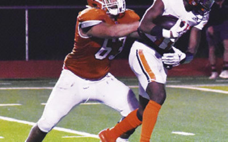 JIM JACKSON of Caldwell makes a tackle last Friday against Smithville in Caldwell.