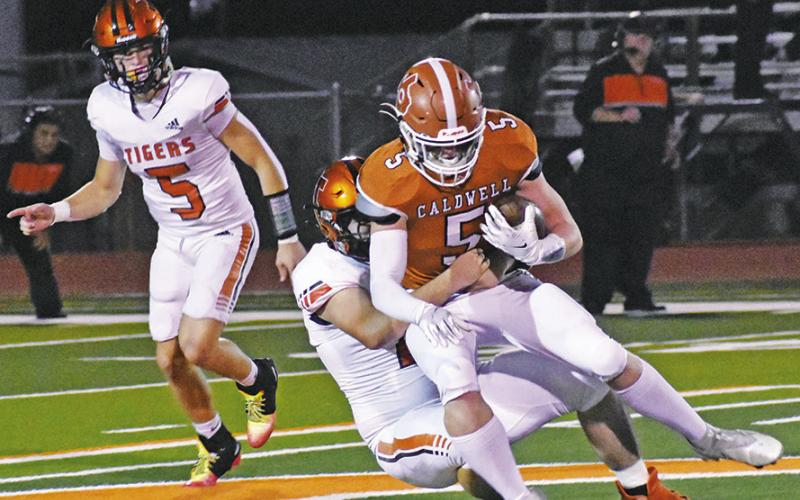 CORBIN STEWART OF Caldwell makes a catch last Friday against Smithville in Caldwell. -- Tribune photo by Roy Sanders