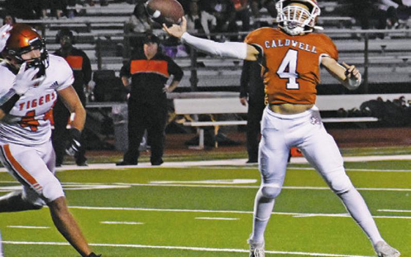 KORBIN BURNS OF Caldwell hurls this pass against Smithville last Friday. The Hornets lost 21-14. -- Tribune photo by Roy Sanders