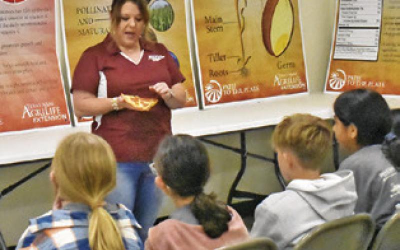 BURLESON COUNTY AGRILIFE Extension Agent Holly Narro addresses these fifth-graders on May 7 at the Burleson County Ag &amp;amp; Health Safety Day held at the county expo center.