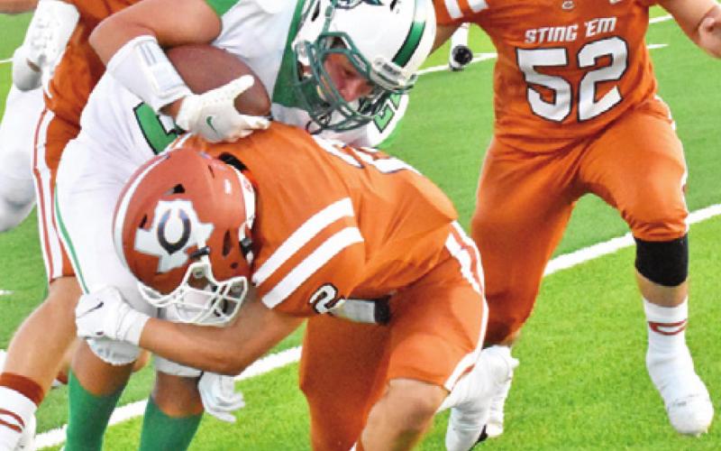 THE HORNET DEFENSE led by Blane Garza, Brandon Hirsch and Jamin White tackle this Hempstead ball carrier.