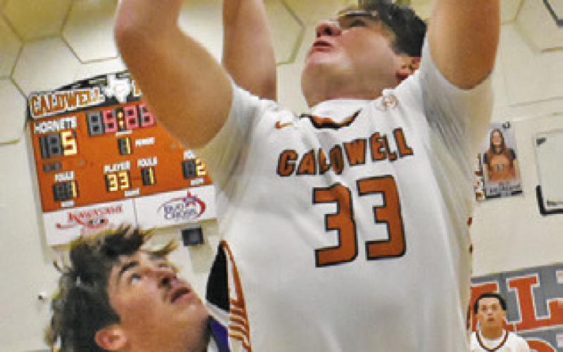 KOY MACIK of Caldwell leaps high for this shot last Friday against Navasota. Tribune photo by Roy Sanders