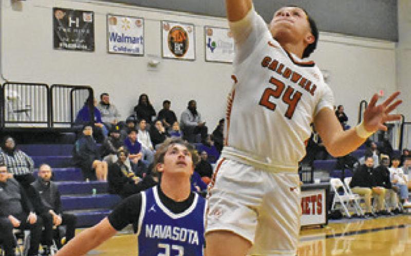 CORBIN BURNS of Caldwell moves in for this layup shot against Navasota. Tribune photo by Roy Sanders