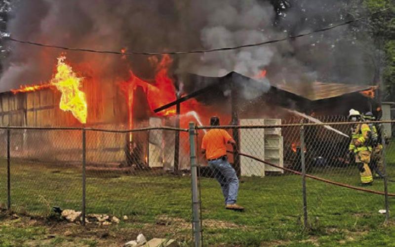 FIREFIGHTERS SPRAY WATER on this workshop on April 7 off Elm Drive at Cade Lake. Caldwell and Deanville firefighters responded. Photo courtesy of Caldwell Volunteer Fire Department