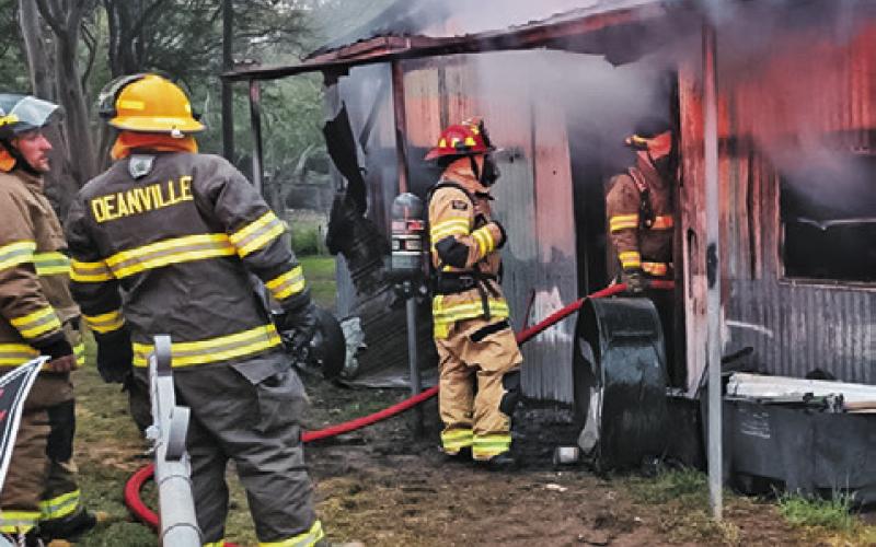 DEANVILLE AND CALDWELL volunteer firefighters work the scene of this fire on April 7 off Elm Drive at Cade Lake. Photo courtesy of Caldwell Volunteer Fire Department