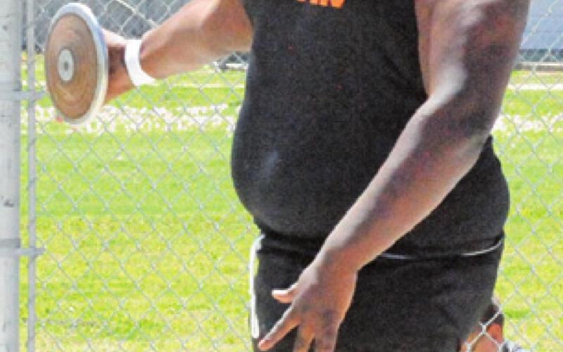 CEDRIC HUDGEN sets to throw the discus during last week’s district track meet.