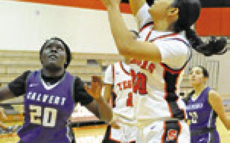 ANNETTE REYNA shoots a basket during the Somerville-Calvert game on Friday. Tribune photo by Denise Squier