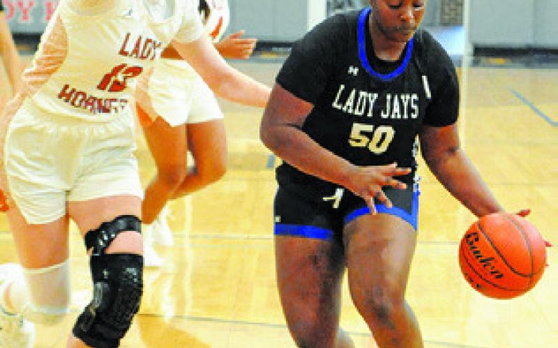 ROZARIA CARTER dribbles past Kaely Brown during last Tuesday’s Caldwell-Snook game at Hornet Gym. Tribune photo by Denise Squier