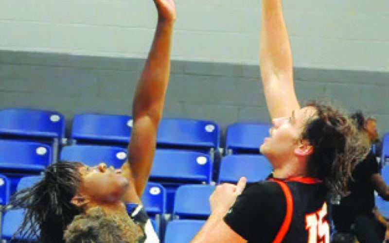 IRMAN SADIC of Somerville takes a shot as this Mumford player defends. Tribune photo by Denise Squier