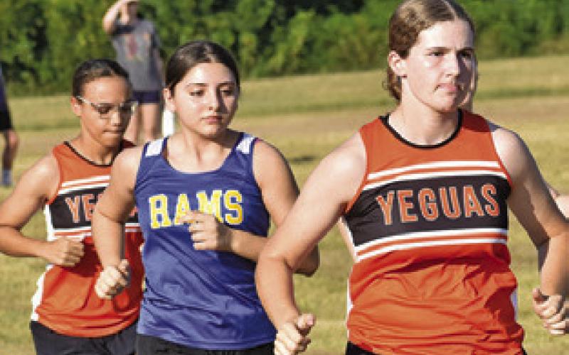 THE LADY YEGUA cross country team runs in the girls JV race at Saturday’s Caldwell XC Invitational. Tribune photo by Roy Sanders