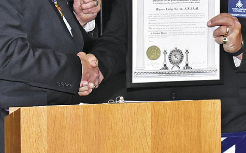 RABORN READER, Grand Master of The Grand Lodge of Texas, makes this presentation to Bill Sargent, Worshipful Master of the Warren Lodge No. 56 in Caldwell.