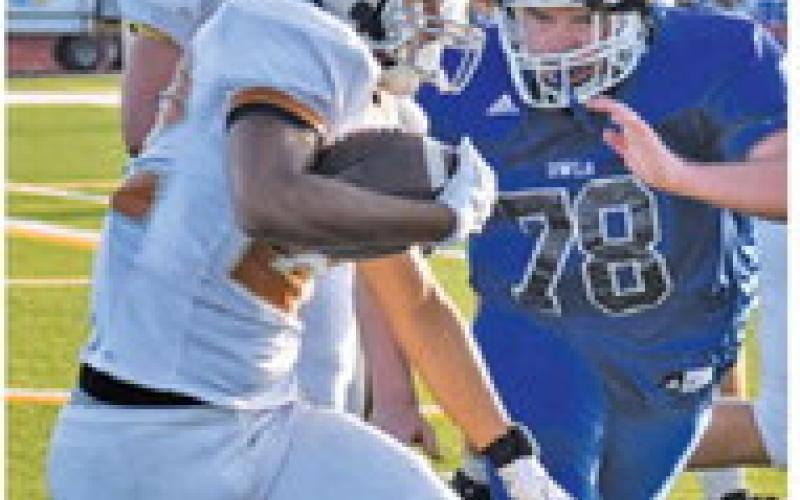 AXAVIER AGUILAR carries the ball for Caldwell in the Anderson-Shiro scrimmage. Tribune photo by Roy Sanders