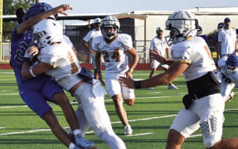 CALDWELL’S DEFENSE MOVES to the ball and forces a turnover against Anderson-Shiro on Aug. 13 in Caldwell. Tribune photo by Roy Sanders