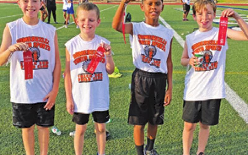 SOMERVILLE YOUTH SPORTS competed at the Bryan Thunderbolts Invitational Track Meet on June 30. Pictured are, from left, Jaxton Groce, Jaxson Schoppe, Elijah Pleasant and Conner Richardson.