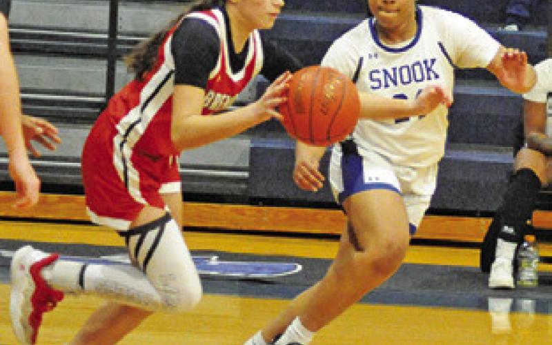 ROMANI JOHNSON defends against a Bremond player during the Snook-Bremond game on Friday night at Snook High School Tribune photo by Denise Squier