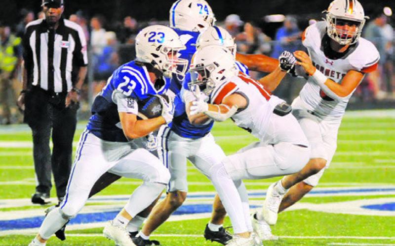CALDWELL’S RICK JAMES reaches and Tyler Boyd runs the Robinson ball carrier. Tribune photo by Denise Squier
