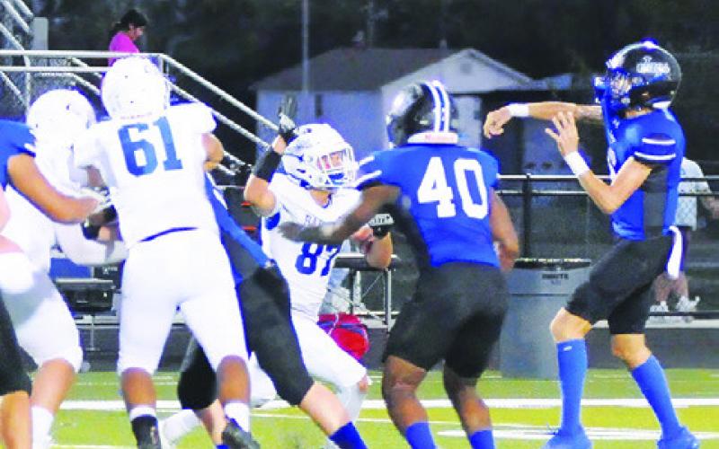 BRETT WITHEM OF Snook hurls this pass against Bartlett. Tribune photo by Denise Squier