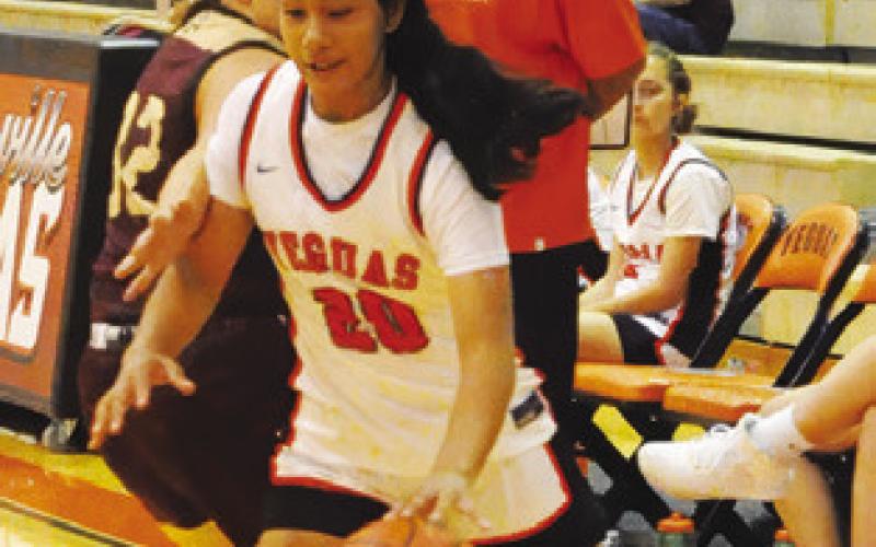 ANNETTE REYNA dribbles past a Milano player during the Lady Yeguas’ 51-20 loss to Milano last Friday. Reyna scored three points in the loss. Tribune photo by Denise Squier