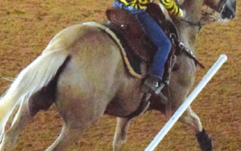 THIS RIDER KNOCKS over a pole during the Burleson County Saddle Club’s Youth Rodeo on Saturday. -- Tribune photo by Denise Squier