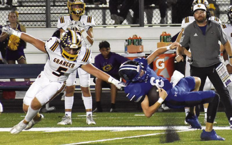 SNOOK QUARTERBACK BRETT Withem falls as this Granger defender approaches in last Friday’s game in Snook. Tribune photo by Roy Sanders