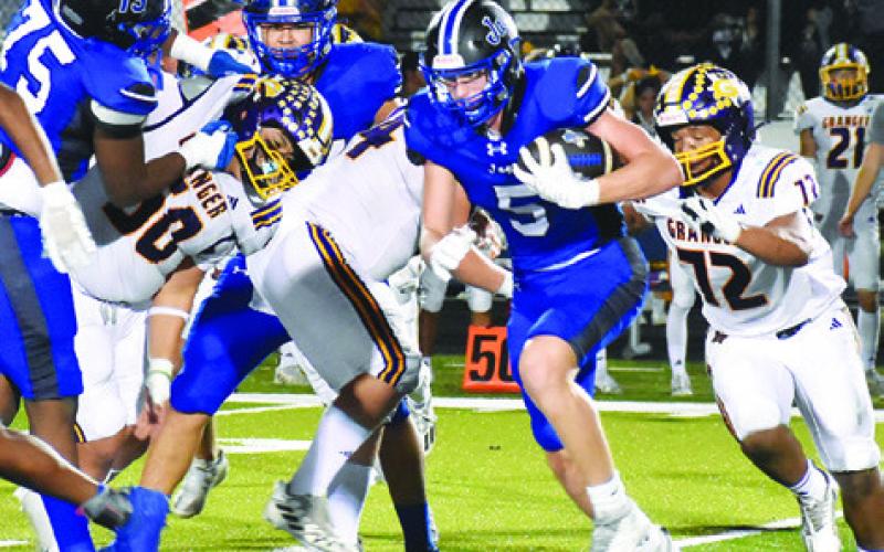 SNOOK’S BRAYDEN MACIK carries the ball against Granger in last Friday’s game in Snook. The Bluejays lost 35-8. Tribune photo by Roy Sanders