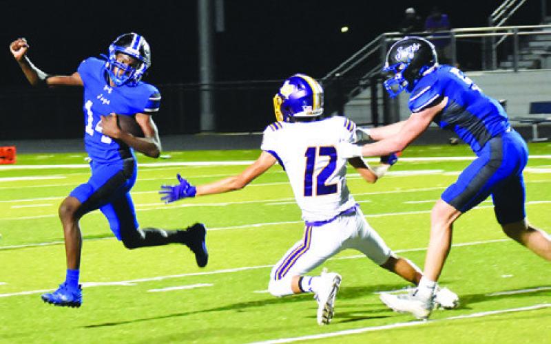 BUD MOORE CARRIES the ball for Snook as Brayden Macik blocks in last Friday’s game against Granger in Snook. Tribune photo by Roy Sanders