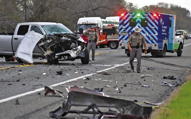 DPS TROOPERS WORK THE scene of this accident on State Highway 36 South on Sunday. Tribune photo by Roy Sanders