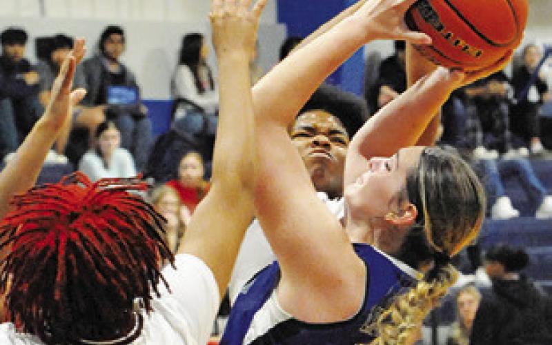 ALEXIS MACIK is triple-teamed by Hearne during the Snook Lady Jay Basketball Tournament. -- Tribune photo by Denise Squier