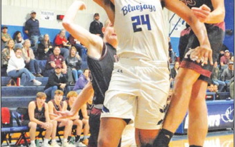 DEKENDRICK DAWSON TAKES a shot dedpite heavy defensive pressure against Iola. -- Tribune photo by Denise Squier