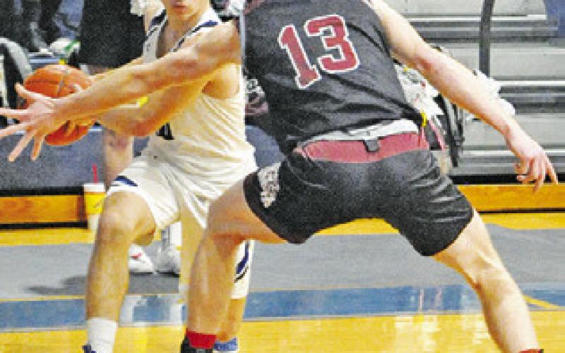LANCE LARA of Snook dribbles the ball around this Iola defender in Friday’s game.