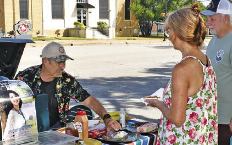JIM HARRELL MAKES a sale at the Farmers Market on Saturday in downtown Caldwell.