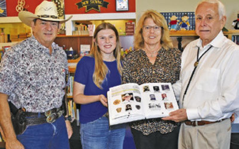 RONNIE ERWIN JOINS Burleson County Sheriff Bill Rios, right, and Caylee and Sherri Hermes at his book presentation at the Caldwell library.