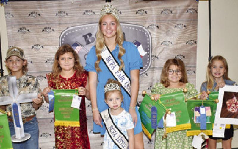 J.W. MUZNY WON a grand champion in metal work, Caroline McDermott for jewelry and jelly, Lynndee McDermott for needlework, jelly, jewelry, a quilt and a bird house, and Hattie Herrmann for needlework and photography. Joining them are Burleson County Fair Queen Hadleigh Novosad and Little Miss Avery Grace Freeman.