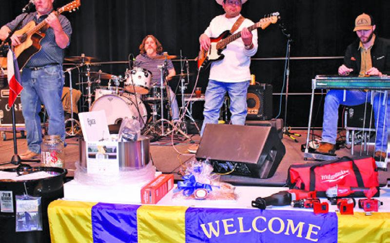 THE CROSSROADS BAND plays on Saturday night at the Denim Dinner and Dance held by the Caldwell Burleson County Lions Club at the Caldwell Civic Center. A live auction was also held. Tribune photo by Roy Sanders