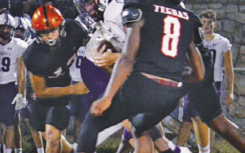 THE SOMERVILLE DEFENSE, including Keke Daniels and Ian Teague move in for a tackle against Thrall.