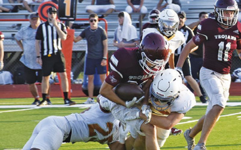 CALDWELL’S JOHN FRYREAR and another Hornet defender make a tackle against Troy. -- Tribune photo by Roy Sanders
