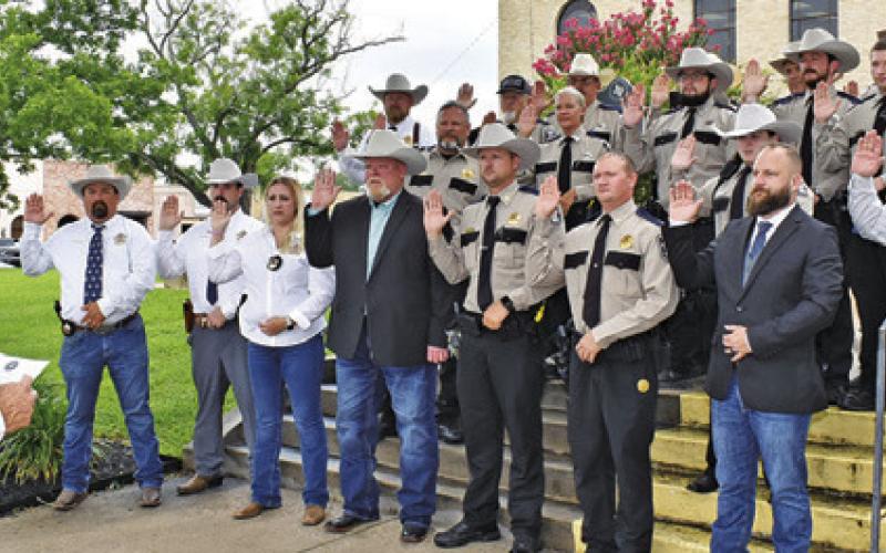SHERIFF BILL RIOS ADMINISTERS the oath of office to Burleson County’s deputies on Tuesday, June, 10, on the steps of the Burleson County Courthouse.