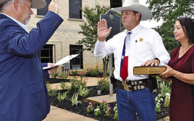BILL RIOS IS joined by his wife Irma Rios for his swearing in as Burleson County sheriff. County Judge Keith Schroeder administered the oath of office on the steps of the county courthouse.
