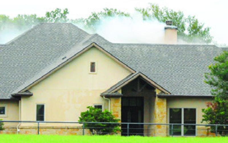 SMOKE IS seen coming from this house on County Road 100 last Thursday, July 18.
