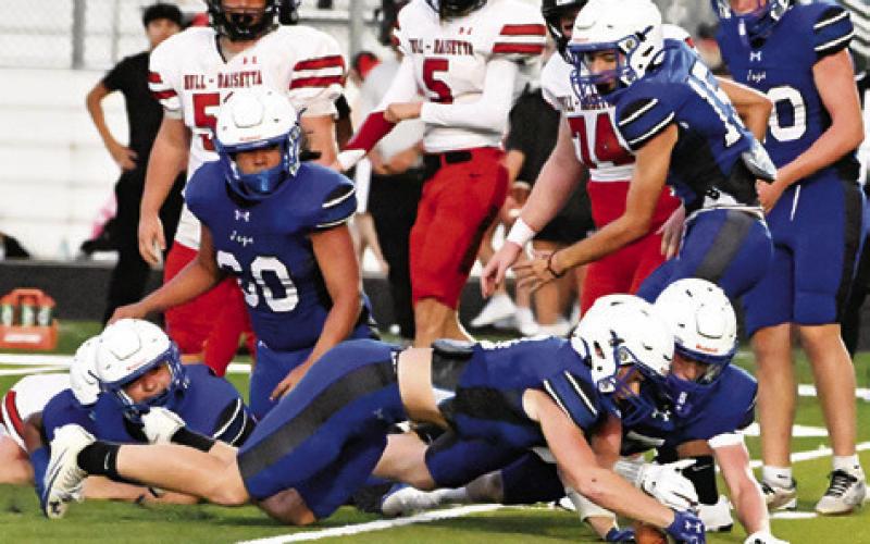SNOOK’S BRENT TURNER and Wyatt Lopez recover this fumble against Hull-Daisetta. The Bluejays won their opener 42-14. Tribune photo by Denise Squier